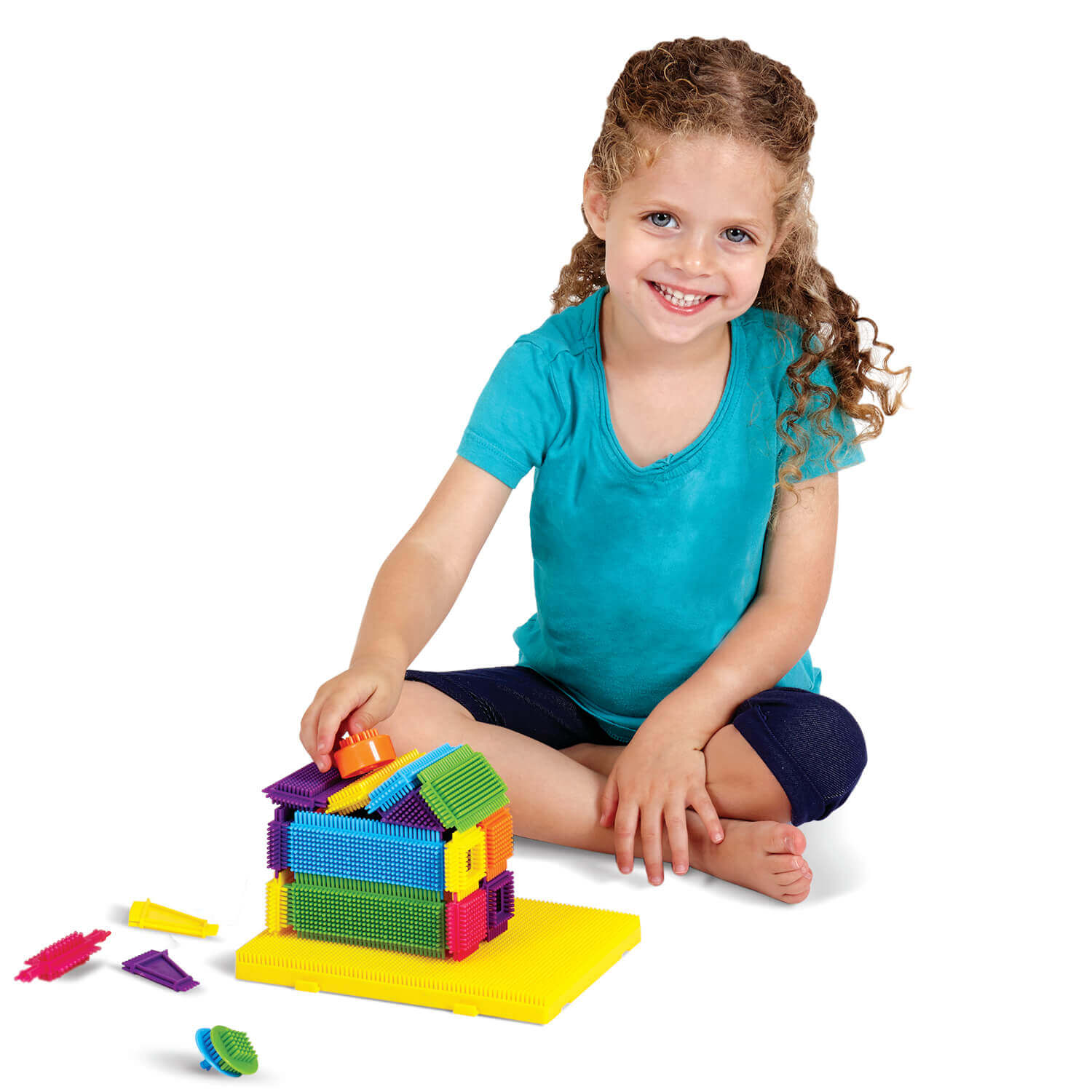 girl building with travel brix bristle blocks